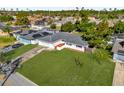 Aerial view of a charming single-story home with a lush lawn and a neatly maintained landscape at 728 Vicksburg St, Deltona, FL 32725