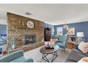 Cozy living room with a stone fireplace, comfortable seating, and hardwood floors at 728 Vicksburg St, Deltona, FL 32725