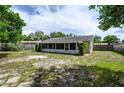 Large backyard with a screened patio and space for outdoor activities at 1016 Martex Dr, Apopka, FL 32703