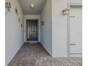 Covered entryway featuring a classic front door, brick flooring, and decorative wall accents at 105 Cerise Ct, Daytona Beach, FL 32124