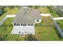 Aerial view of a home featuring a screened-in patio, brick fire pit, and fenced-in yard at 108 Blanco Dr, Deland, FL 32724