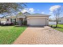 Exterior view of a charming one-story home with a two-car garage at 108 Blanco Dr, Deland, FL 32724