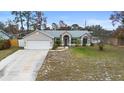 House exterior with a driveway and a grassy yard at 1081 Treadway Dr, Deltona, FL 32738