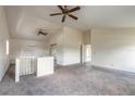 Spacious living room with vaulted ceilings, ceiling fans, and neutral carpet at 1195 10Th St, Daytona Beach, FL 32117