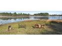 Lakeside backyard with relaxing seating overlooking tranquil lake and natural Florida setting at 149 Sheryl Dr, Deltona, FL 32738