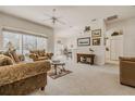 Spacious living area with natural light, ceiling fan, and open floor plan connecting to dining area at 163 Chrysanthemum Dr, Ormond Beach, FL 32174