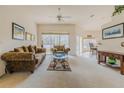 Bright living room with large windows, neutral carpet, and comfortable seating arrangement at 163 Chrysanthemum Dr, Ormond Beach, FL 32174