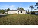 Charming single-story home with a well-manicured lawn and attached two car garage at 177 Rosedale Dr, Deltona, FL 32738