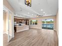 Open-concept living room featuring wood floors, modern lighting, and access to the lake at 177 Rosedale Dr, Deltona, FL 32738