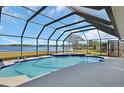 Inviting screened-in pool with beautiful lake views, perfect for relaxation and outdoor enjoyment at 2075 Little Farms Ct, Deltona, FL 32738