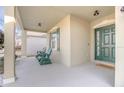 Front porch with green rocking chairs, offering a relaxing space at 242 W Fiesta Key Loop, Deland, FL 32720