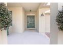 Inviting front porch with green chairs and a charming entryway at 242 W Fiesta Key Loop, Deland, FL 32720