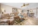 Inviting living room featuring a comfortable sofa, ceiling fan, and tile floors at 2711 N Halifax Ave # 184, Daytona Beach, FL 32118
