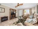 Comfortable living room featuring a media center, fireplace, and tile floors at 2711 N Halifax Ave # 184, Daytona Beach, FL 32118
