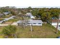 Aerial view of a cozy home surrounded by lush greenery in a peaceful neighborhood at 303 Warwick Ave, Ormond Beach, FL 32174