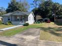 House exterior showcasing a driveway and well-maintained lawn at 309 N Boston Ave, Deland, FL 32724