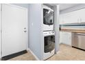 Convenient in-unit laundry featuring a stacked washer and dryer, adjacent to the kitchen area at 3180 Ocean Shore Blvd # 309, Ormond Beach, FL 32176