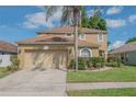 Attractive home featuring a two-car garage, manicured lawn, and beautiful landscaping at 3633 Sickle St, Orlando, FL 32812