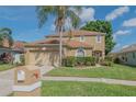 Lovely home featuring a manicured lawn, mature trees, and an inviting entrance at 3633 Sickle St, Orlando, FL 32812