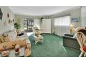 Comfortable living room featuring a floral sofa and a large window, allowing for ample natural light at 600 N Boundary Ave # 114B, Deland, FL 32720
