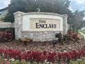 Stone sign for 'The Enclave' community with colorful landscaping at 6301 Swanson St, Windermere, FL 34786