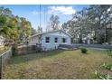 Home with a freshly painted exterior, manicured lawn, and a privacy fence at 829 Madison Ave, Daytona Beach, FL 32114