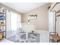 Bright room with a grand white piano and white tile flooring, filled with natural light at 893 S Dean Cir, Deltona, FL 32738