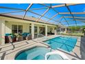 Inviting screened-in pool and spa area, perfect for relaxation and entertaining with covered patio space at 9580 Sw 71St Loop, Ocala, FL 34481