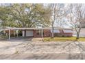 The exterior of a brick home with a carport provides a welcoming view from the street at 1117 Berkshire Rd, Daytona Beach, FL 32117