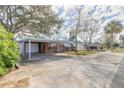 Charming single-story red brick home featuring a covered carport and well-maintained front yard at 1117 Berkshire Rd, Daytona Beach, FL 32117
