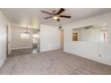 Bright living room with neutral carpet, ceiling fan, and large window to let in natural light at 1117 Berkshire Rd, Daytona Beach, FL 32117