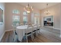 Elegant dining room with large windows, grand chandelier, and plenty of natural light at 1120 Caldwell Ave, Orange City, FL 32763