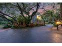 Secluded home with mature trees and well-maintained landscaping creating a private and serene atmosphere at 120 Beach St, Ponce Inlet, FL 32127