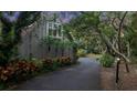 Secluded home with mature trees and well-maintained landscaping creating a private and serene atmosphere at 120 Beach St, Ponce Inlet, FL 32127