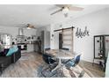 Cozy dining area with modern ceiling fan, table, and decorative barn door to another room at 1268 Bel Aire Dr, Daytona Beach, FL 32118