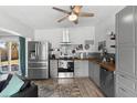 Beautiful kitchen with stainless steel appliances, stylish backsplash, wood countertops and gray cabinetry at 1268 Bel Aire Dr, Daytona Beach, FL 32118