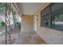 Inviting covered front porch with stone flooring and brick siding detail at 137 Lucerne Dr, Debary, FL 32713