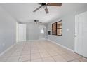 Bright living room featuring tile flooring, ceiling fans, and freshly painted walls at 137 Lucerne Dr, Debary, FL 32713