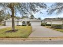 Charming one-story home featuring a two-car garage and well-maintained landscaping at 1429 Carlow Cir, Ormond Beach, FL 32174