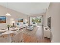 Bright living room with hardwood floors, contemporary furnishings, and sliding glass doors at 1429 Carlow Cir, Ormond Beach, FL 32174