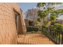 A wooden balcony featuring black metal railings and views of the surrounding trees at 179 Moonstone Ct, Port Orange, FL 32129