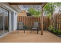 Cozy outdoor patio featuring two chairs with a privacy fence at 179 Moonstone Ct, Port Orange, FL 32129