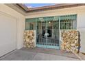 A gated entrance featuring stone columns and an ornate metal gate providing security and architectural detail at 1924 Seclusion Dr, Port Orange, FL 32128