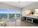 Bright living room with floor to ceiling windows and tile floors offers breathtaking water views at 2 Oceans West Blvd # 1905, Daytona Beach Shores, FL 32118