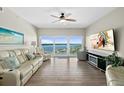 Bright living room with floor to ceiling windows and tile floors offers breathtaking water views at 2 Oceans West Blvd # 1905, Daytona Beach Shores, FL 32118