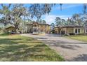 Elegant estate showcasing lush landscaping, a circular driveway, and a spacious multi-car garage for luxurious living at 2111 Hontoon Rd, Deland, FL 32720