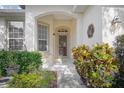 Inviting front entrance with decorative accents and lush plantings at 215 Coleton Ln, Deland, FL 32724