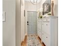 Inviting entryway featuring stylish décor, shoe cabinet, and a decorative area rug at 221 Aston Grande Dr, Daytona Beach, FL 32124