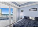 Light-filled main bedroom with balcony access offers serene ocean views and comfortable living at 2403 S Atlantic Ave # 209, Daytona Beach Shores, FL 32118