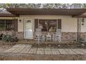 Inviting front porch with rocking chairs, decorative details, and brick accents at 270 Sandyhook Ln, Deland, FL 32724